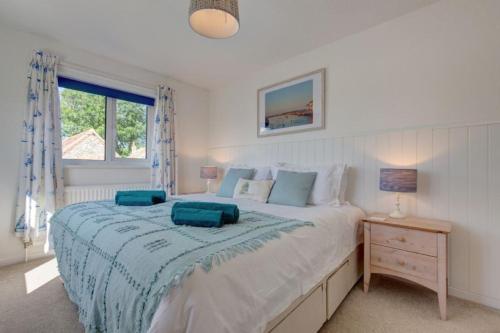 a bedroom with a large bed with two pillows on it at Egret in South Creake