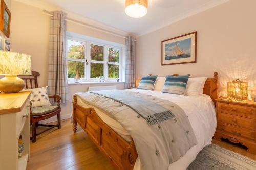a bedroom with a large bed and a window at Waterside in Wiveton