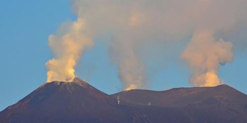 a mountain with smoke coming out of it at PetraSicula Apartment in Acitrezza