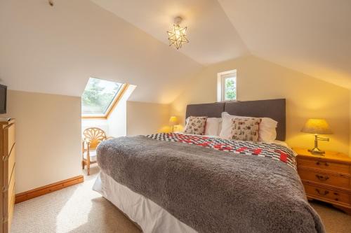 a bedroom with a large bed and a window at The Old Chapel in Pentney