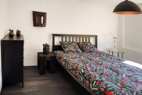 a bedroom with a bed with a colorful comforter at MARCEL APARTMENT in Krościenko