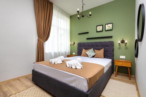 a bedroom with a bed with two towels on it at Kapana Guest House on Central Pedestrian street with Parking included in Plovdiv