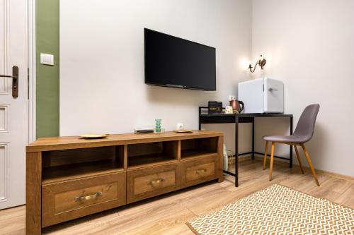 a living room with a television on a wall at Kapana Guest House on Central Pedestrian street with Parking included in Plovdiv
