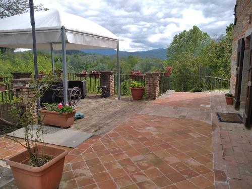 a patio with a white tent and some plants at Villa Belvedere in Pieve Fosciana