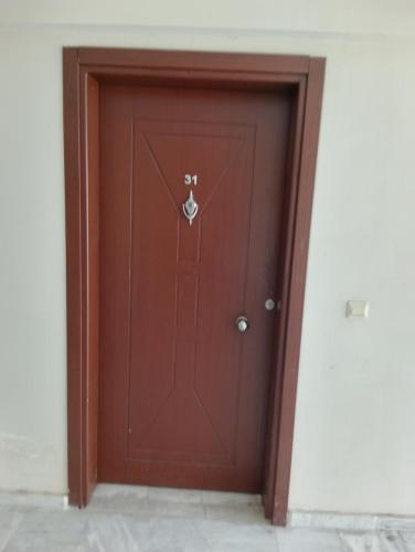 a wooden door with the number on it at Rainford aprt in Denizli