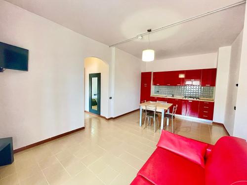 a living room with red cabinets and a red couch at Aparthotel Isabella in Sciacca