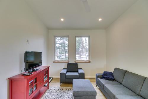 a living room with a couch and a tv at Columbia Falls Home with Patio Near Glacier NP! in Columbia Falls