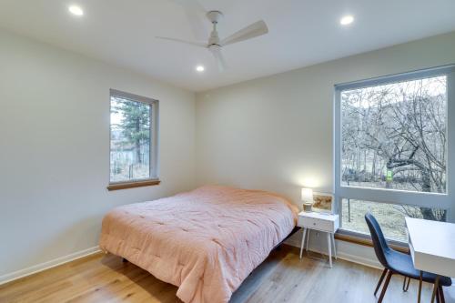 a bedroom with a bed and a desk and a window at Columbia Falls Home with Patio Near Glacier NP! in Columbia Falls