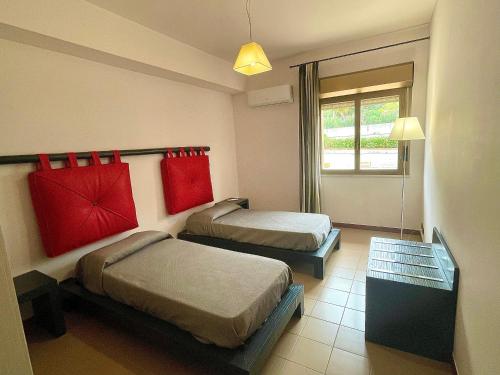 a hotel room with two beds and a window at Aparthotel Isabella in Sciacca