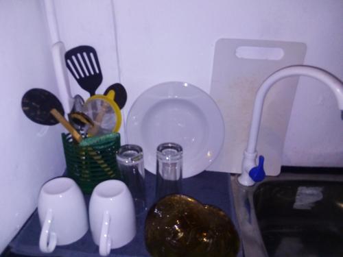a kitchen counter with a sink and utensils at Villa Maleena in Hikkaduwa