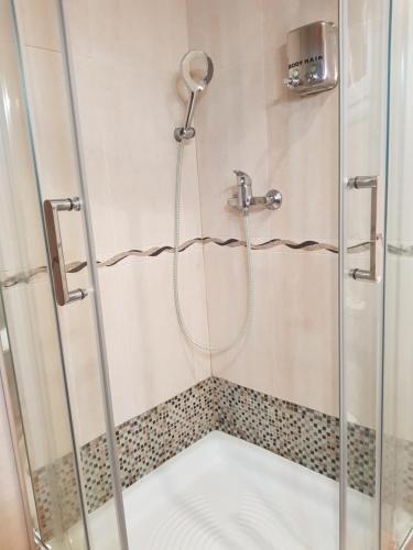 La salle de bains est pourvue d'une douche avec une porte en verre. dans l'établissement Apt a Calafell plage, à Calafell