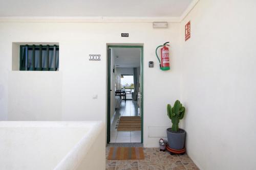 a hallway with a fire extinguisher on the wall at Al Sole Studios residence Playa Roca in Costa Teguise