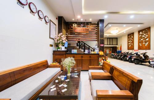 a restaurant with benches and motorcycles in a room at Arise Seaside Hotel in Nha Trang