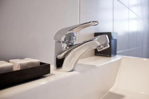 a bathroom sink with a silver faucet on it at Million dollar view Spanish Hacienda Style Luxury Villa in Jan Thiel in Jan Thiel