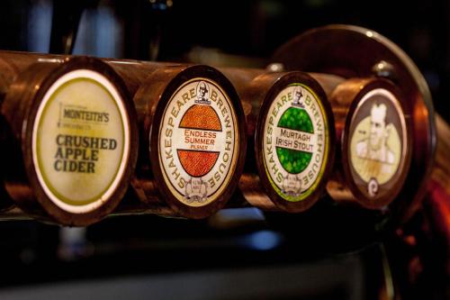a close up of four different gauges on a shelf at The Shakespeare Hotel in Auckland