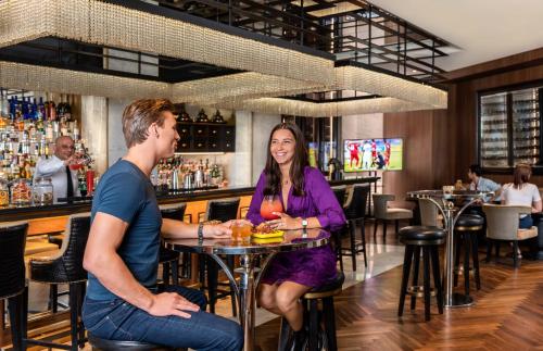 a man and woman sitting at a bar at The H Dubai in Dubai