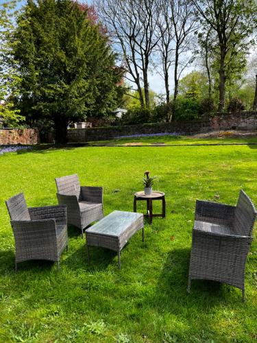 a group of chairs and a table in the grass at No.1 Beechcroft in Liverpool