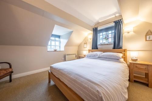 a bedroom with a large bed and a window at Garden Cottage in Ringstead