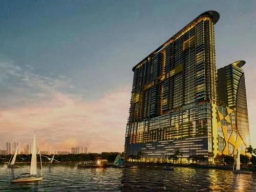 a large building on a body of water with boats at Silverscape Residence Melaka Luxury Seaview Suite - FREE WIFI in Melaka