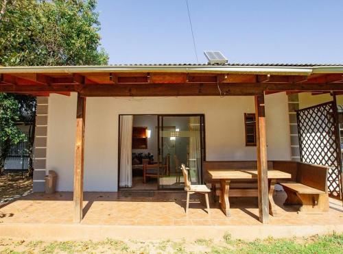 a wooden pavilion with a table and a bench at Golden Candle Guest House in Roodepoort