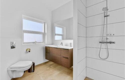 a bathroom with a toilet and a sink and a shower at Amazing Home In Hvide Sande With Outdoor Swimming Pool in Hvide Sande