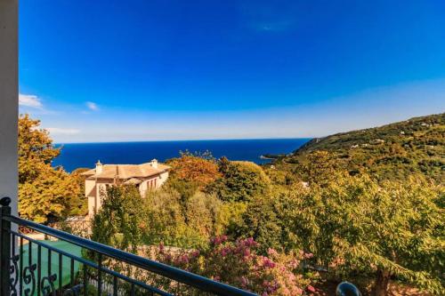 a house on a hill with the ocean in the background at Villa Zina Agios Dimitrios in Agios Dimitrios