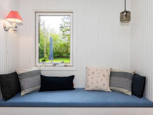 a room with a blue couch with a window at 6 person holiday home in Vesløs-By Traum in Øsløs
