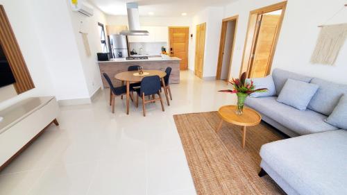 a living room with a couch and a table at Amar'e Aparthotel & Spa in Las Terrenas