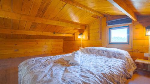 a bedroom with a bed in a wooden cabin at Casa Los Bartolos Vélez Rubio by Ruralidays in Vélez Rubio