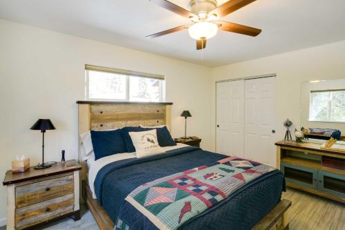 a bedroom with a bed and a ceiling fan at Tranquil Lake Almanor Getaway with Grill! in Westwood