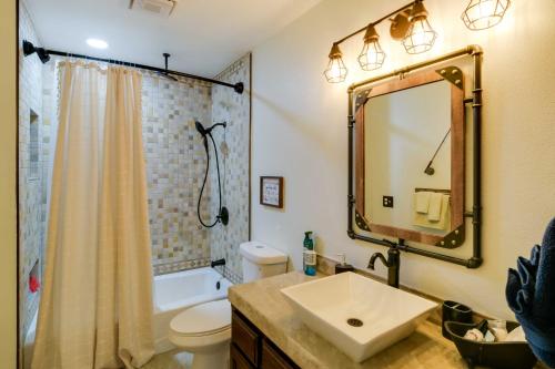 a bathroom with a sink and a toilet and a mirror at Tranquil Lake Almanor Getaway with Grill! in Westwood