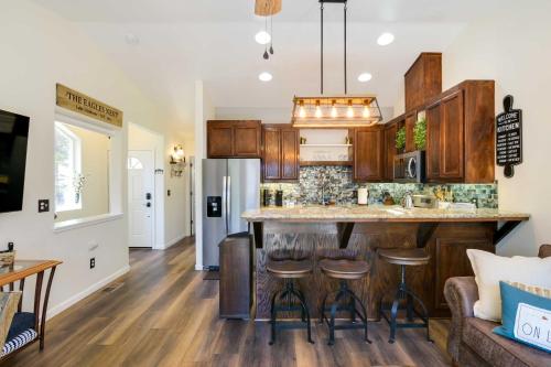 a kitchen with a large island with bar stools at Tranquil Lake Almanor Getaway with Grill! in Westwood