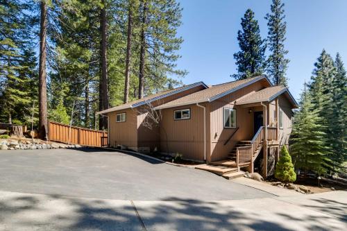 a small house in the woods with a driveway at Tranquil Lake Almanor Getaway with Grill! in Westwood