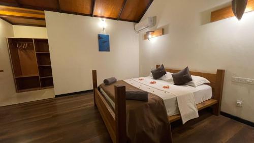 a bedroom with a bed in a room at RISING SUN BEACH VIEW in Thinadhoo