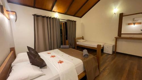 a small room with two beds and a mirror at RISING SUN BEACH VIEW in Thinadhoo