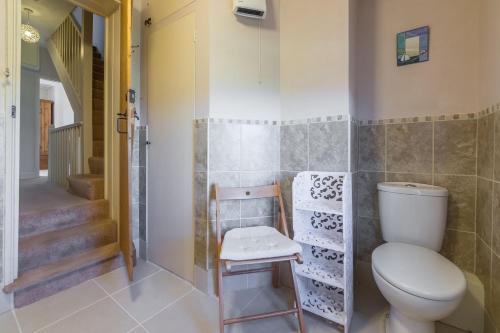 a bathroom with a toilet and a staircase at 4 Harbour View in Brancaster