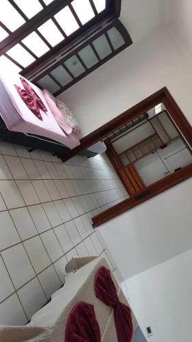 two bunk beds in a room with a window at Pousada Believe in Praia Grande