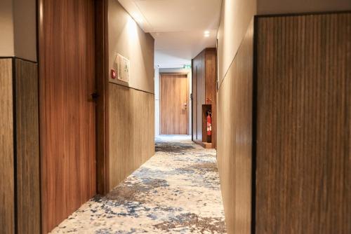 a hallway with a damaged floor with a damaged corridor at CARD Hôtel in Paris