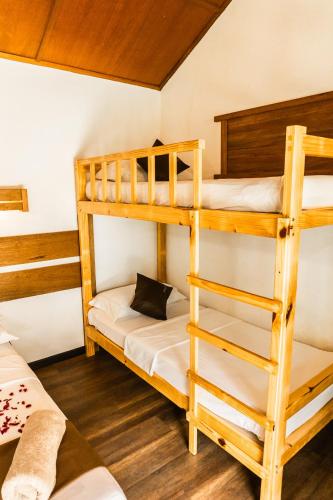 a bunk bed room with two bunk beds at RISING SUN BEACH VIEW in Thinadhoo