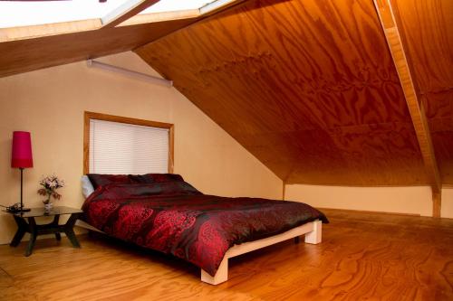 una camera con un grande letto e un soffitto in legno di Bellview a Bellthorpe