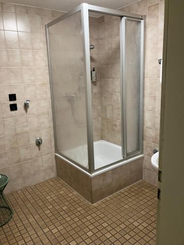 a bathroom with a shower with a tub and a sink at pop-up stuub feldberg in Feldberg