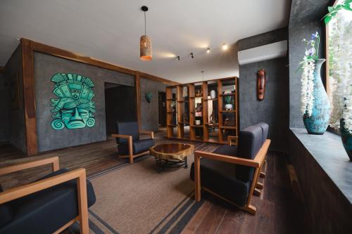 a living room with furniture and a painting on the wall at Kai Tulum in Tulum