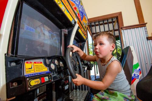 a young child playing a video game in a truck at NRMA South West Rocks Holiday Park in South West Rocks