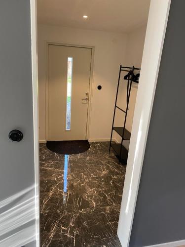 a hallway with a marble floor and a door at Casa Blanca in Strandbaden