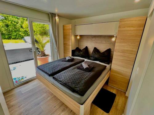 ein großes Bett in einem Zimmer mit einem großen Fenster in der Unterkunft Feriendomizil Schleich am Steinriegl in Bad Gleichenberg