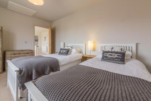 a bedroom with two beds in a room at Anchorage in Brancaster