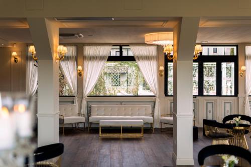 a room with couches and chairs and a window at Relais Sassa al Sole in San Miniato