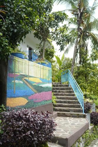 a mural on the side of a building with stairs at Ling & Louie's Mountain in Mayong