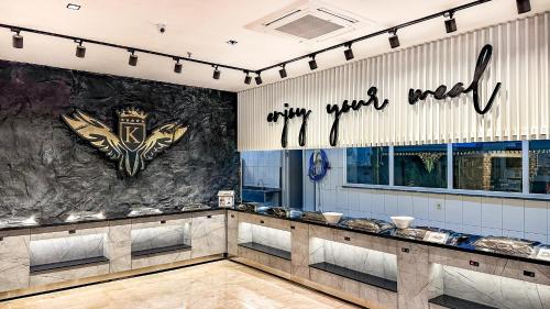a restaurant with a sign on the wall at Kırbıyık Resort Hotel - Alanya in Kargicak