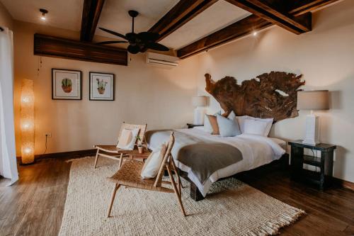 a bedroom with a large bed with a tree headboard at Sansara Surf Yoga & Resort in Cambutal